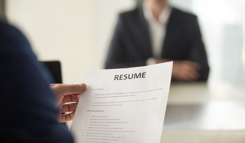 Image of a person holding a resume