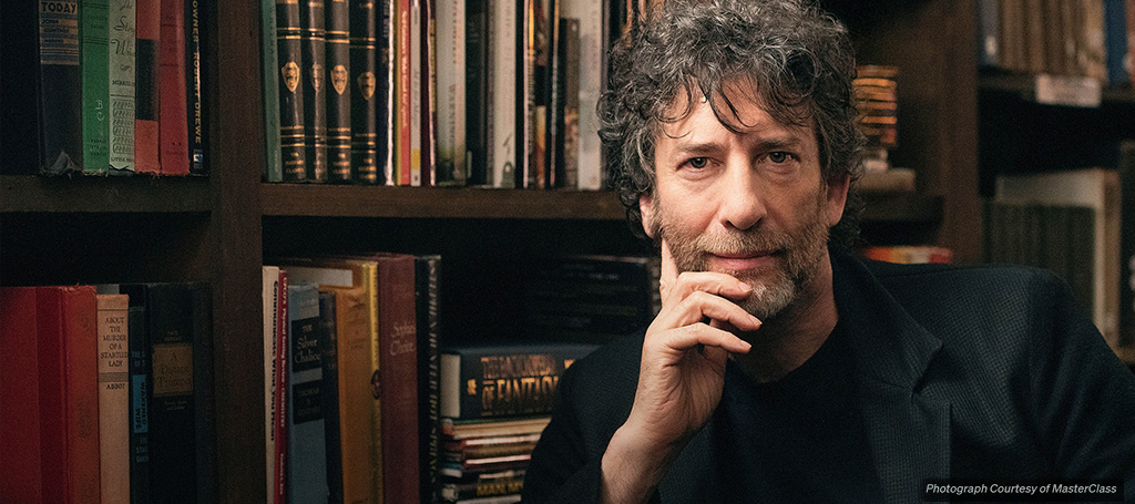 Author Neil Gaiman poses in a library